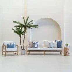Set of 7 pacific cove outdoor sofa cushions is arranged neatly on a white sofa.