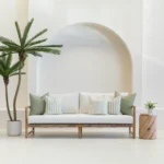 Pacific sage coloured outdoor sofa cushions in a set of 5 are styled on a white sofa.