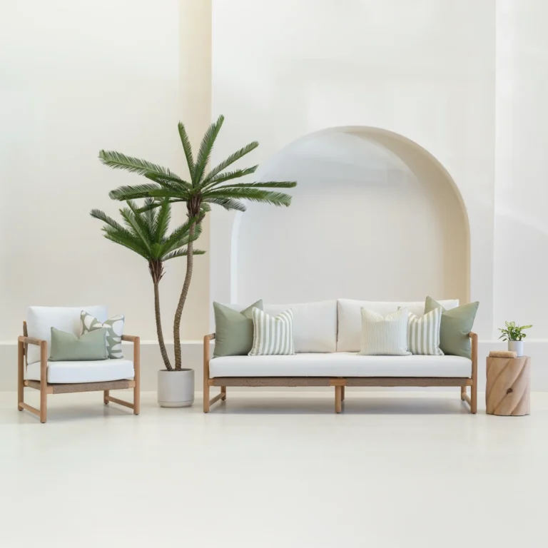7 outdoor sofa cushions in a pacific sage colour shown on a white sofa.