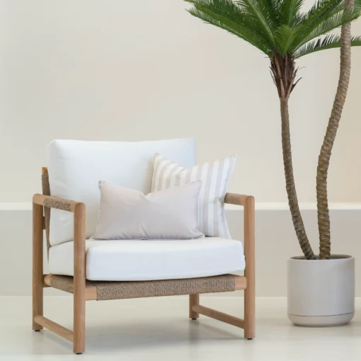 A wooden armchair displaying 2 pacific sand outdoor cushions.