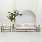 Outdoor seating with white sofa displaying a set of 7 pacific sand outdoor sofa cushions on it.