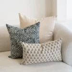 A natural-coloured sofa is styled with the set of 3 designer covers.