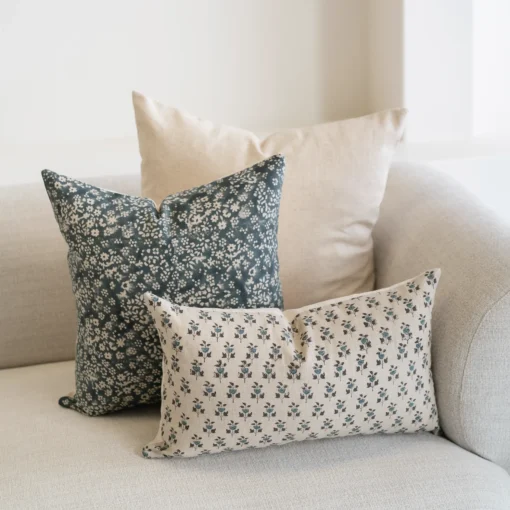 A natural-coloured sofa is styled with the set of 3 designer covers.