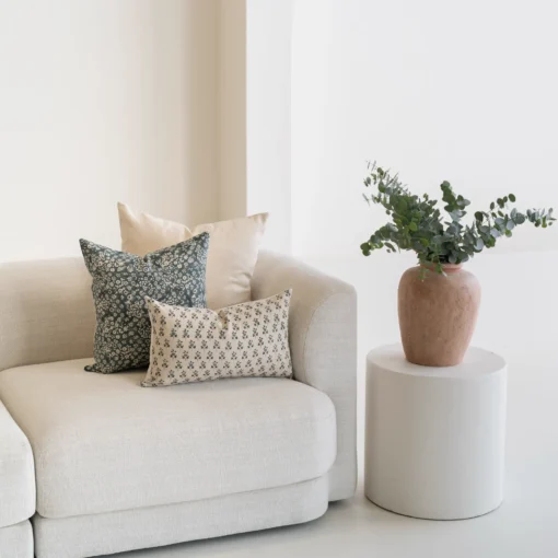 The corner of a natural sofa with 3 designer covers from the Sable set.