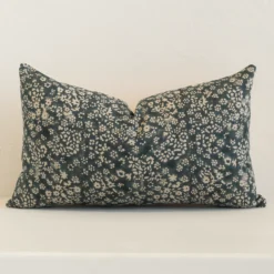 Front view of floral rectangle cushion. Crafted from a special linen material in a dark moss green and natural colour.