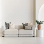Living room scene with 5 designer sofa cushions arranged on a sofa.