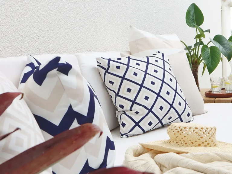 Beige and navy examples of what colour outdoor cushions look good on a light outdoor lounge seat.