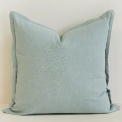 Close-up of eucalyptus blue linen cushion with soft textured finish.