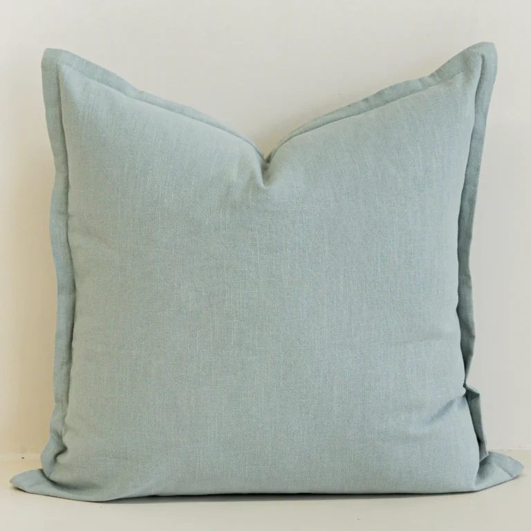 Close-up of eucalyptus blue linen cushion with soft textured finish.