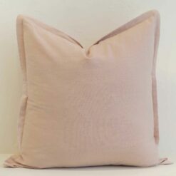 Blush linen cushion cover with a soft flange edge and a light, airy tone.