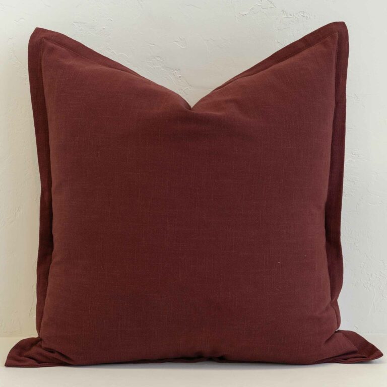 Burgundy linen cushion cover with a rich, deep colour and tailored edge finish.