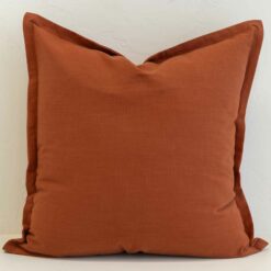 Burnt orange linen cushion cover with a warm earthy hue and refined flange detail.