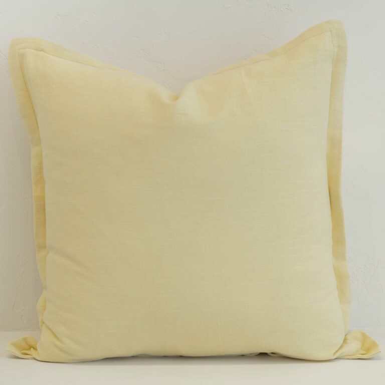 Butter yellow linen cushion cover with a gentle, uplifting tone and soft structured edge.