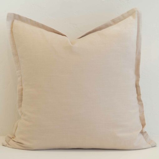 Cream linen cushion cover with a soft neutral tone and refined flange edge.