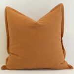 Ginger linen cushion cover with a rich golden warmth and a clean, structured edge.
