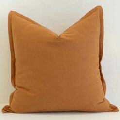 Ginger linen cushion cover with a rich golden warmth and a clean, structured edge.