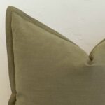Close-up of khaki linen cushion corner with subtle stitched edge finish