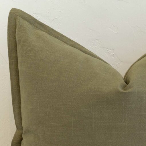Close-up of khaki linen cushion corner with subtle stitched edge finish