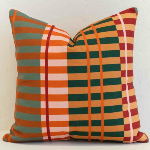 Bold plaid cushion cover with warm orange, green and red tones in a striking, modern pattern.