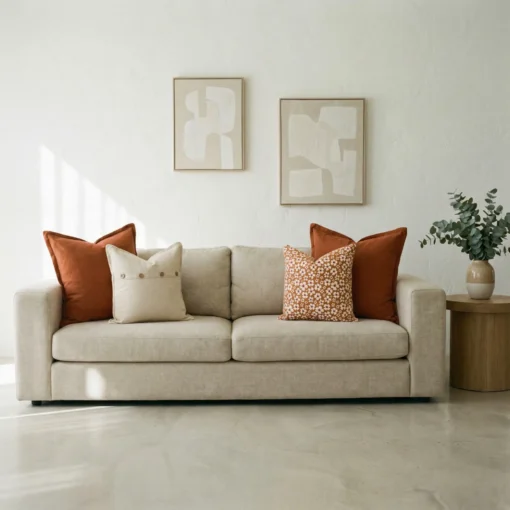 Marenca burnt orange cushions styled on beige sofa with patterned accent cushions.