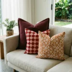 Marenca diamond cushions on beige sofa with floral and plaid accent cushions.