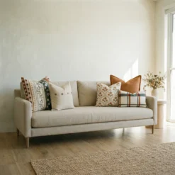 Marenca ginger cushions displayed on sofa with mixed floral, striped and plaid designs.