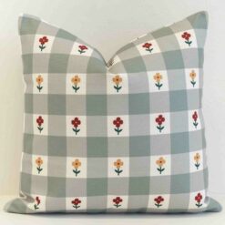 Gingham check cushion cover in muted sage tones with small scattered floral details for a gentle, country feel.