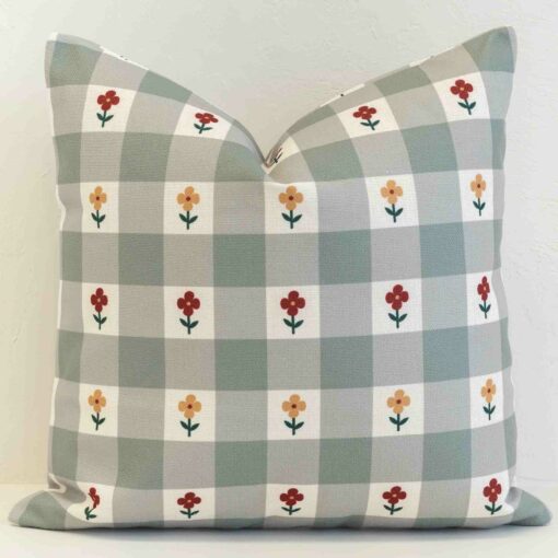 Gingham check cushion cover in muted sage tones with small scattered floral details for a gentle, country feel.
