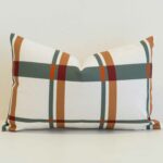 Plaid rectangular cushion cover in soft ivory with muted green, rust and ochre lines for a warm, tailored look.