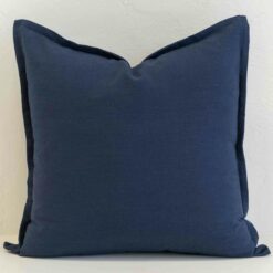 Navy linen button cushion cover with natural wooden buttons on the reverse, adding a thoughtful, textural detail.