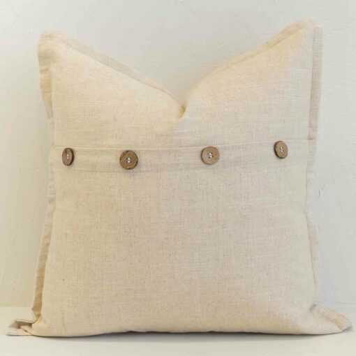 Oatmeal linen button cushion cover finished with wooden buttons for a warm, understated accent.