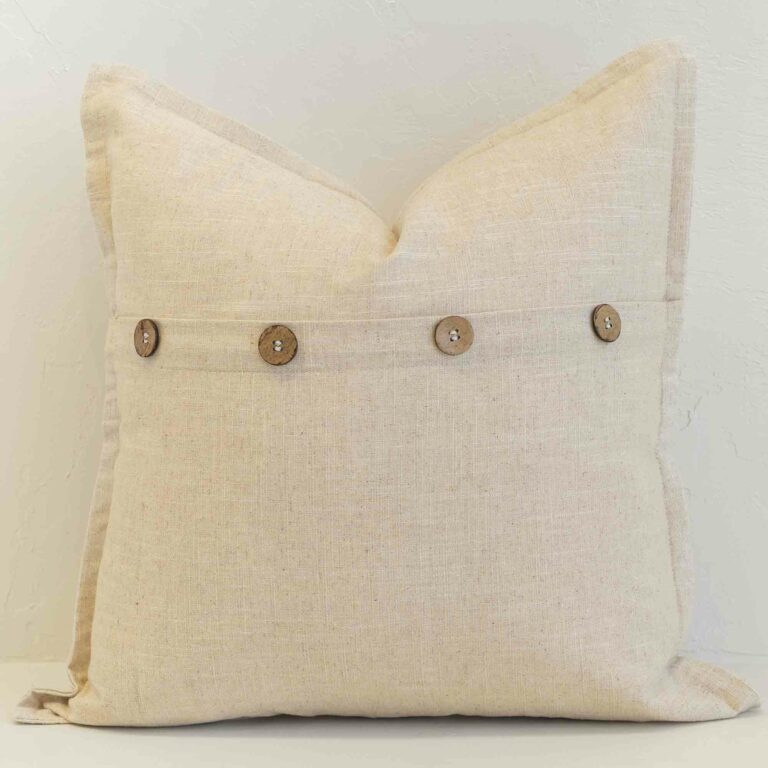 Oatmeal linen button cushion cover finished with wooden buttons for a warm, understated accent.