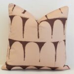 Waterproof outdoor cushion cover featuring a soft arch pattern in warm clay and chocolate tones, creating a bold yet relaxed statement.