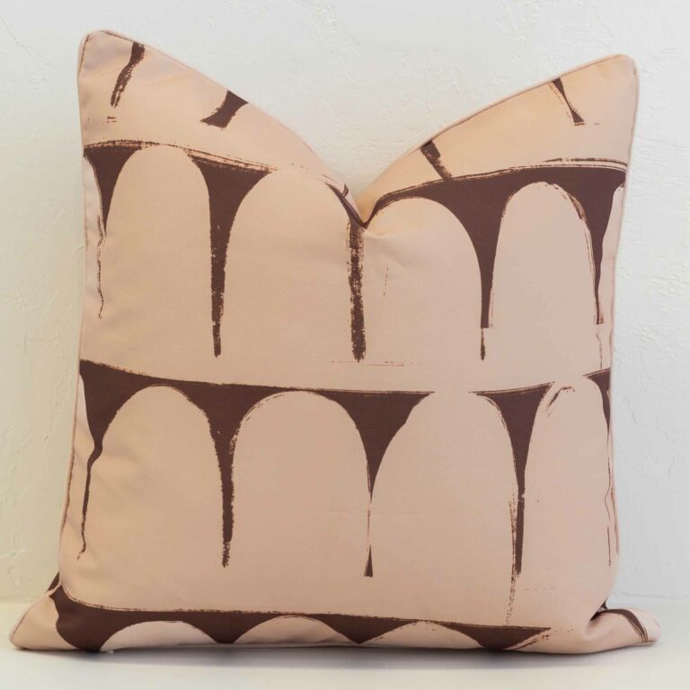 Waterproof outdoor cushion cover featuring a soft arch pattern in warm clay and chocolate tones, creating a bold yet relaxed statement.