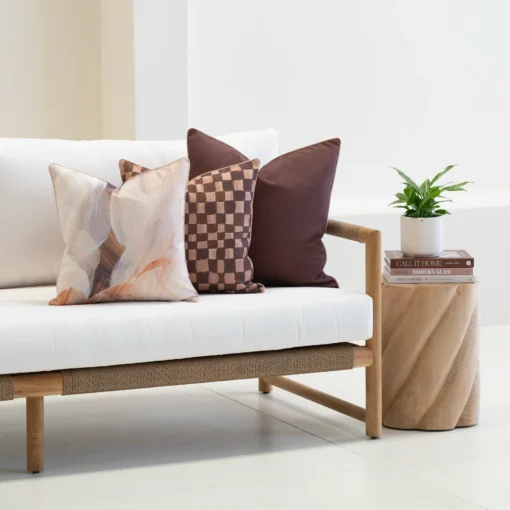 Solterra cushions in earthy tones with abstract and check patterns on sofa.