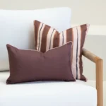 Solterra cushions in brown and blush tones with stripe and plain designs on sofa.