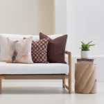 Solterra cushions set with abstract and check patterns on outdoor sofa.