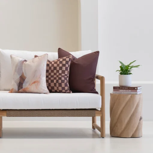 Solterra cushions set with abstract and check patterns on outdoor sofa.