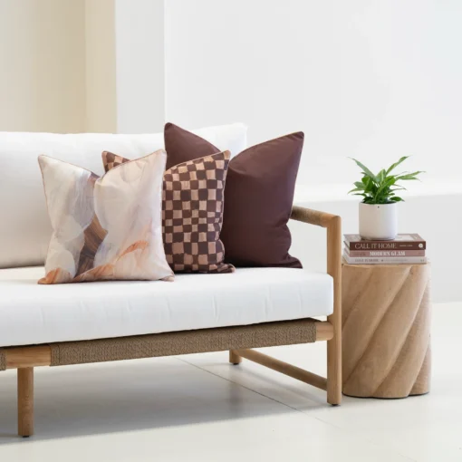 Solterra cushions set with abstract and check patterns on white outdoor sofa.