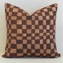 Checkered outdoor cushion cover in layered brown and tan tones, bringing a modern, hand-painted feel with subtle texture.