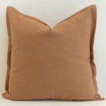 Tan linen cushion cover in a warm, earthy tone that adds natural depth and softness.