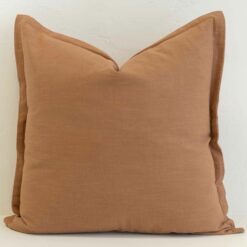 Tan linen cushion cover in a warm, earthy tone that adds natural depth and softness.