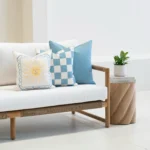 Tropica aqua cushions with sun motif and check pattern styled on sofa.