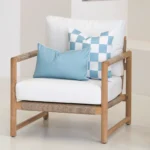 Tropica aqua cushions on armchair with check pattern and solid blue cushion.