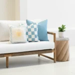 Tropica aqua cushions with sun motif, check pattern and plain blue on sofa.