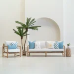 Tropica aqua cushions set with palm, sun and check patterns on sofa.
