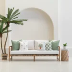 Tropica green cushions styled on outdoor sofa with palm and check patterns.