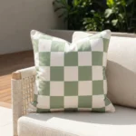 Tropica green check cushion with soft sage and white squares on sofa.