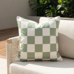 Tropica green check cushion with soft sage and white squares on sofa.