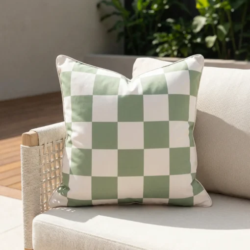 Tropica green check cushion with soft sage and white squares on sofa.